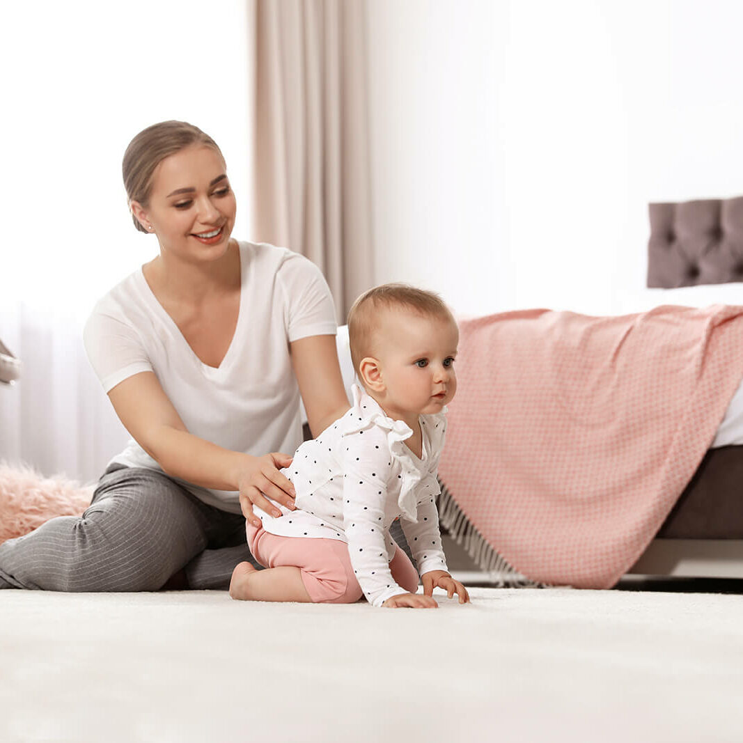 Baby & mother playing on carpet floor | Jimmie Lyles Flooring Gallery